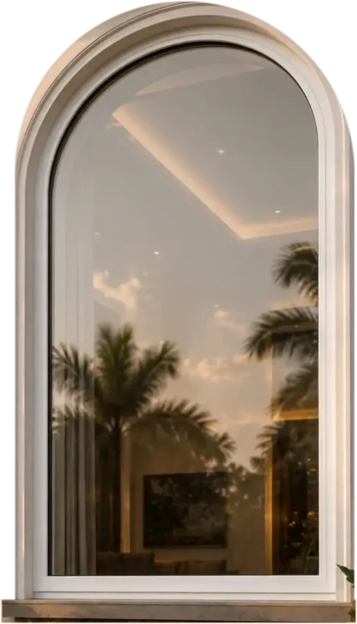 Tall white UPVC arched window on the front of a villa at dusk