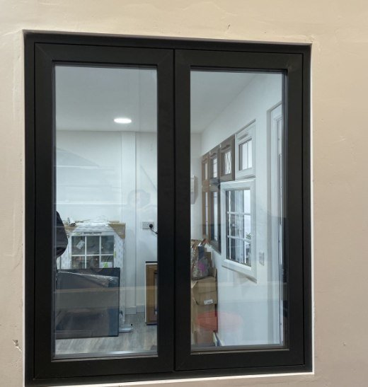Black double casement window set in a white wall