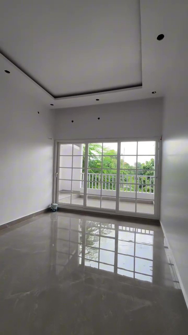 Bright empty room with full-width white UPVC sliding doors to a balcony